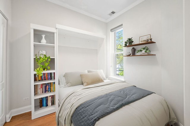 1610 N Whipple St Unit 2, Chicago, IL 60647 - bedroom with light wood-style flooring, ornamental molding, and baseboards