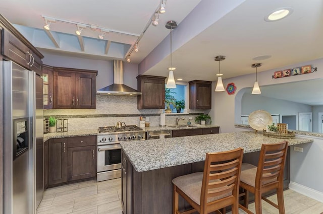 221 8th St, Downers Grove, IL 60515 - kitchen with stainless steel appliances, wall chimney exhaust hood, a sink, backsplash, and dark brown cabinets