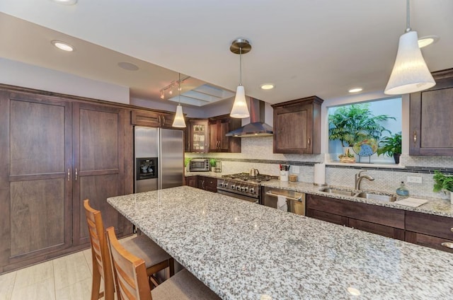 221 8th St, Downers Grove, IL 60515 - kitchen featuring wall chimney range hood, stainless steel appliances, light stone counters, a sink, and decorative backsplash