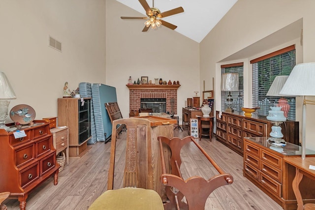 25056 Madison St, Plainfield, IL 60544 - living room featuring light wood-style floors, ceiling fan, high vaulted ceiling, and a fireplace