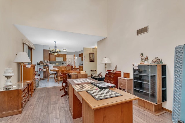 25056 Madison St, Plainfield, IL 60544 - kitchen with a chandelier, white appliances, light wood-type flooring, brown cabinets, and decorative light fixtures