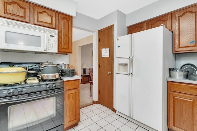 25056 Madison St, Plainfield, IL 60544 - kitchen featuring white appliances, light countertops, brown cabinets, and light tile patterned flooring