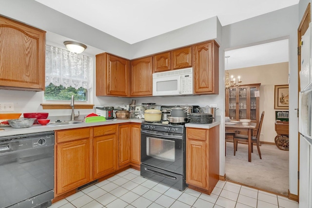 25056 Madison St, Plainfield, IL 60544 - kitchen with black appliances, a sink, light countertops, and a chandelier