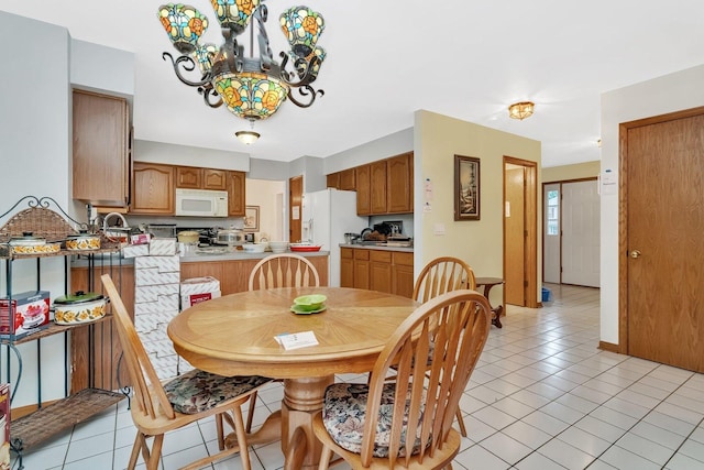 25056 Madison St, Plainfield, IL 60544 - dining area with a chandelier and light tile patterned floors