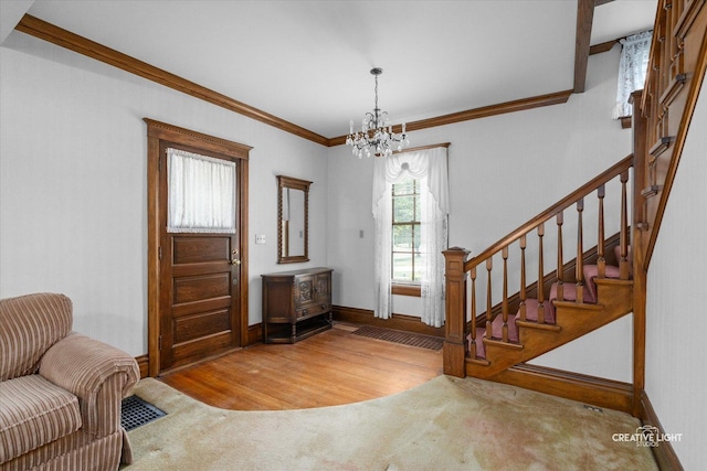 811 W Galena Blvd, Aurora, IL 60506 - entrance foyer with a chandelier, stairway, crown molding, wood finished floors, and baseboards