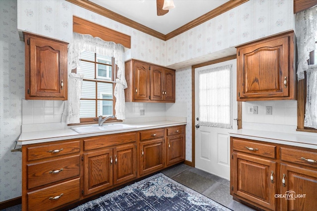 811 W Galena Blvd, Aurora, IL 60506 - kitchen featuring wallpapered walls, a sink, brown cabinets, light countertops, and decorative backsplash