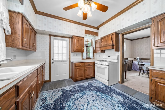811 W Galena Blvd, Aurora, IL 60506 - kitchen with wallpapered walls, white gas stove, ornamental molding, ceiling fan, and light countertops