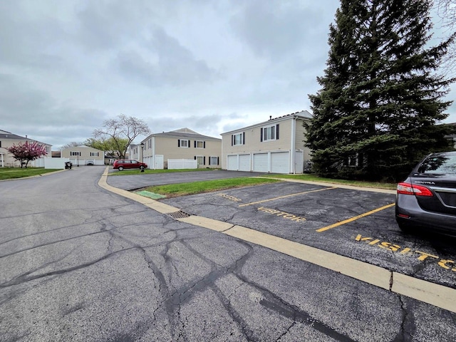 view of front of house with uncovered parking and a residential view