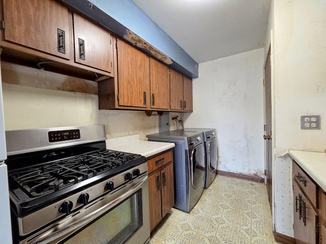 kitchen featuring brown cabinetry, independent washer and dryer, gas range, light countertops, and light floors