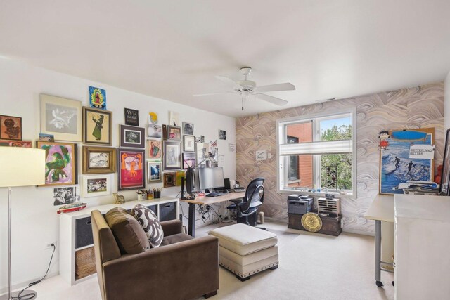 home office featuring ceiling fan, carpet flooring, and wallpapered walls