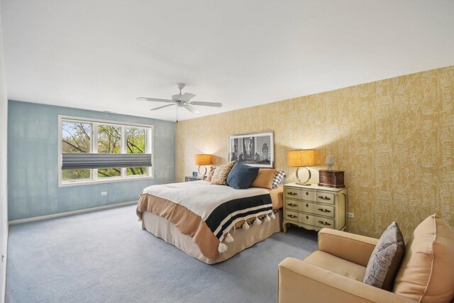 bedroom featuring baseboards, wallpapered walls, carpet, and ceiling fan