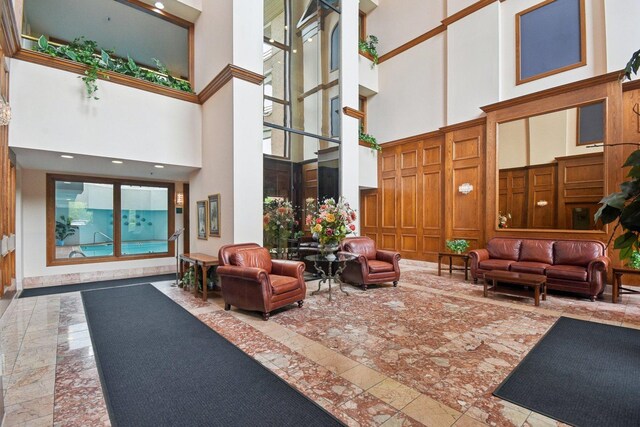 lobby with a towering ceiling and a decorative wall