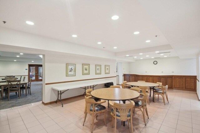 dining room with recessed lighting, light tile patterned floors, and light carpet