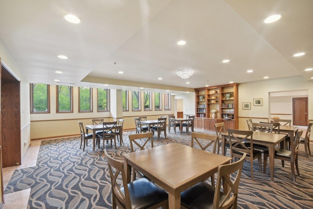 dining room featuring recessed lighting, light colored carpet, and baseboards