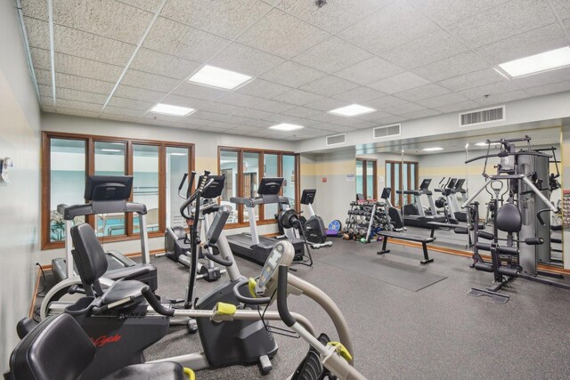 gym featuring a paneled ceiling