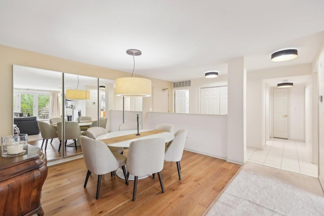 dining space featuring light wood-type flooring
