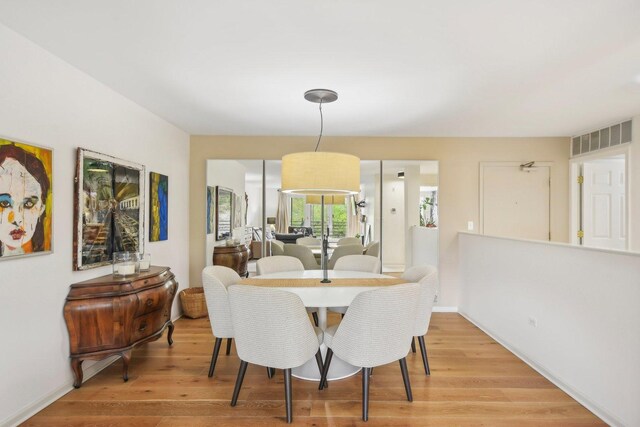 dining room with light wood finished floors and baseboards