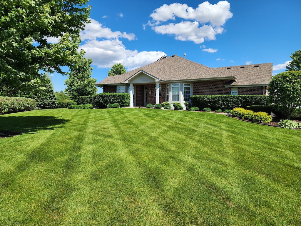 2602 Foxwood Dr Unit 0, New Lenox, IL 60451 - view of front of house with a front yard, brick siding, and a shingled roof