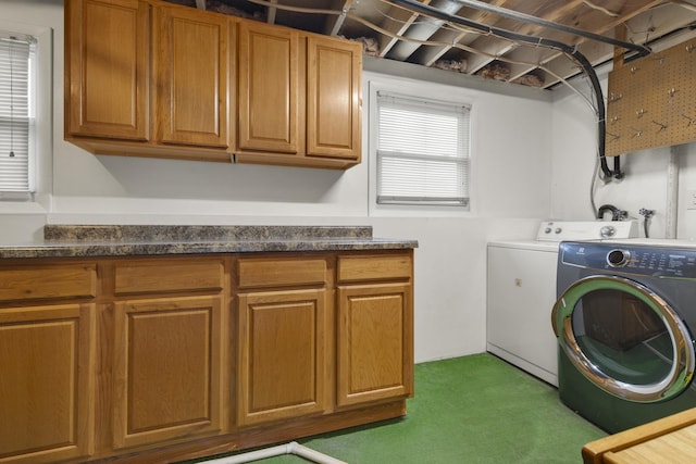laundry area with carpet flooring, cabinet space, and washer and clothes dryer