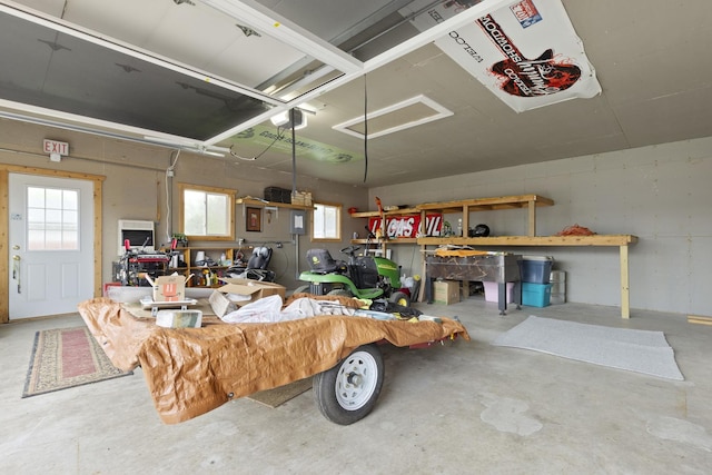 garage with a workshop area and a garage door opener