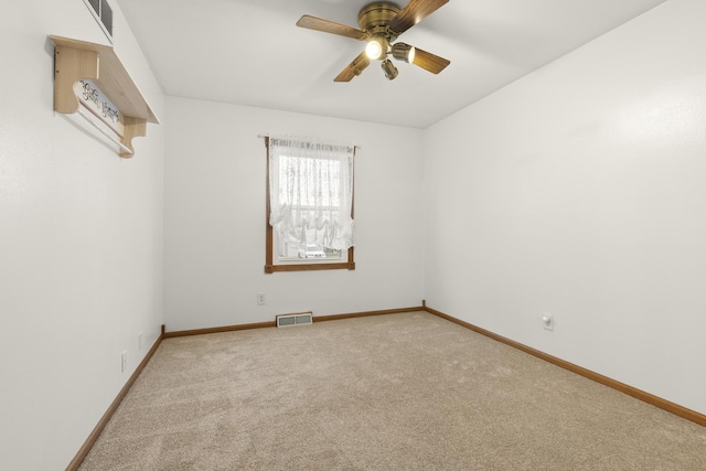 carpeted empty room featuring a ceiling fan, baseboards, and visible vents