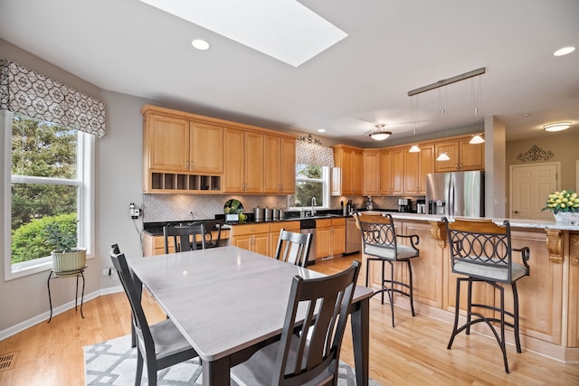 40W434 Triple Oaks Farm Dr, Hampshire, IL 60140 - dining area with light wood-type flooring, baseboards, recessed lighting, and a skylight