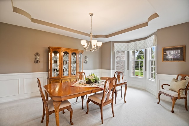 40W434 Triple Oaks Farm Dr, Hampshire, IL 60140 - dining area with a tray ceiling, a chandelier, wainscoting, light carpet, and a decorative wall