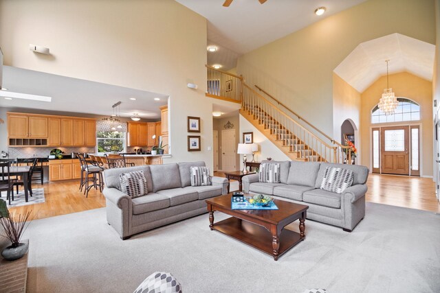40W434 Triple Oaks Farm Dr, Hampshire, IL 60140 - living area with high vaulted ceiling, light wood-style flooring, a chandelier, stairway, and arched walkways
