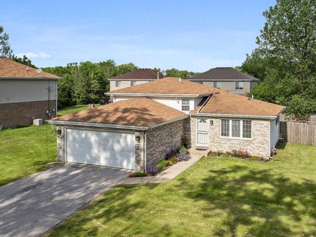 15535 Homan Ave, Markham, IL 60428 - traditional-style home with asphalt driveway and an attached garage