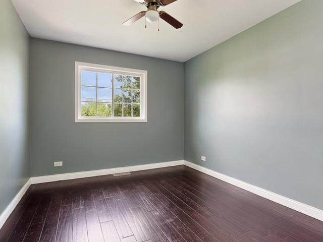 15535 Homan Ave, Markham, IL 60428 - empty room featuring dark wood finished floors and ceiling fan