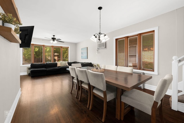 dining area featuring dark wood-type flooring, baseboards, a chandelier, and ceiling fan