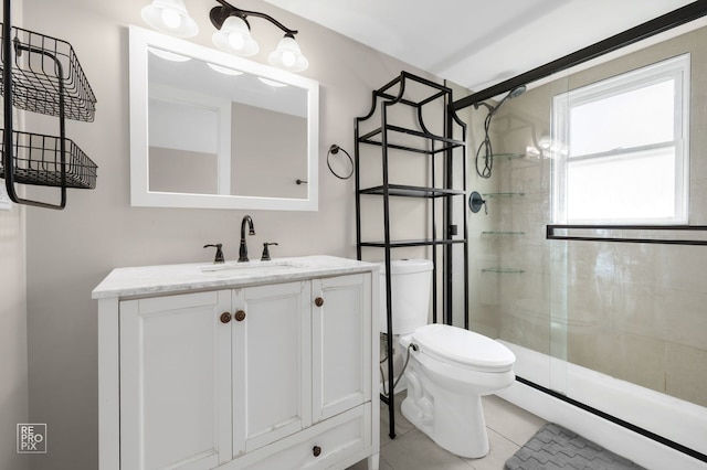 full bath featuring a stall shower, toilet, vanity, and tile patterned flooring
