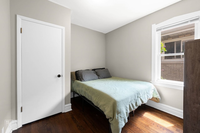bedroom with wood finished floors and baseboards
