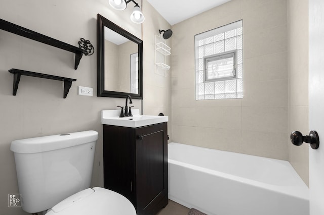 bathroom featuring toilet, vanity, and shower / tub combination
