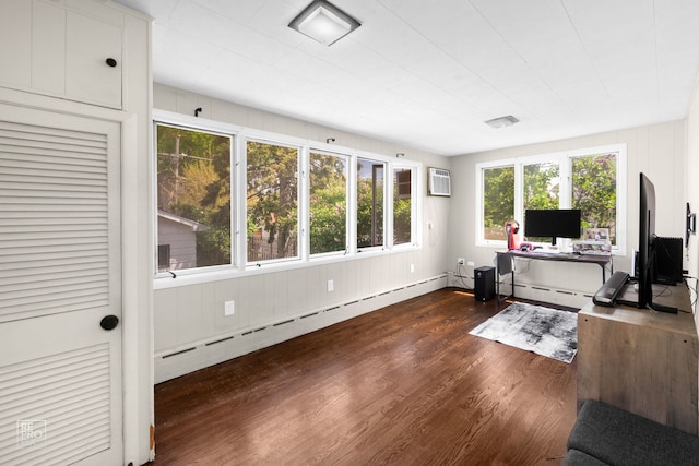 office space featuring baseboard heating, dark wood-style floors, and a wall unit AC