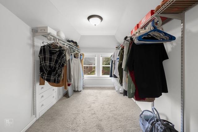 walk in closet featuring carpet floors and lofted ceiling