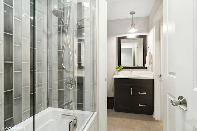 bathroom with vanity, tile patterned flooring, and bath / shower combo with glass door