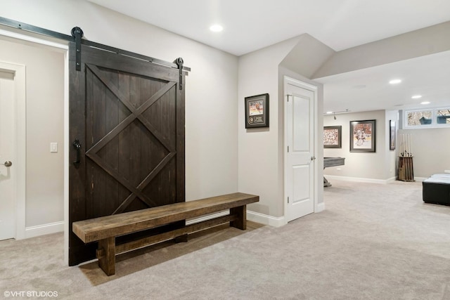 hallway with carpet floors, a barn door, baseboards, and recessed lighting