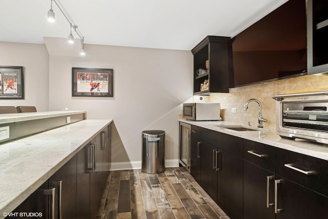 kitchen with decorative backsplash, a toaster, stainless steel microwave, dark wood-style floors, and beverage cooler