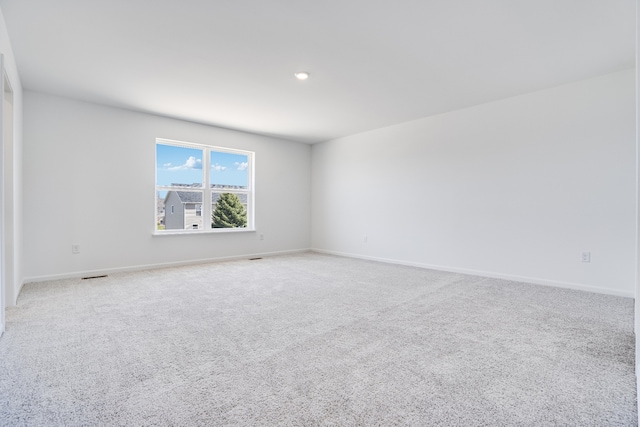spare room with baseboards, carpet flooring, recessed lighting, and visible vents