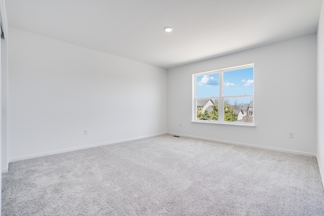 spare room featuring carpet floors, baseboards, and recessed lighting