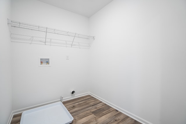 clothes washing area with laundry area, dark wood-style floors, baseboards, and hookup for a washing machine