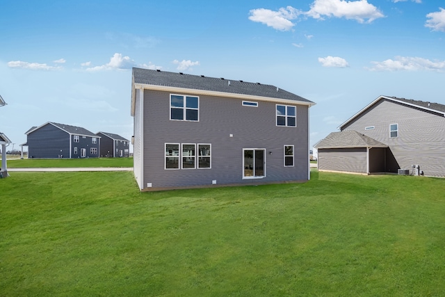 back of house featuring central AC and a yard