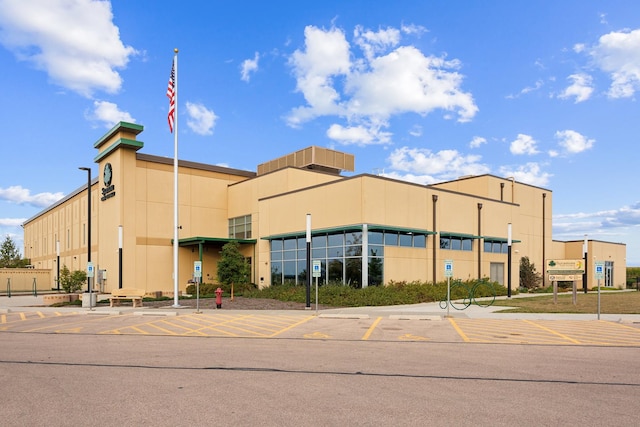 view of building exterior with uncovered parking