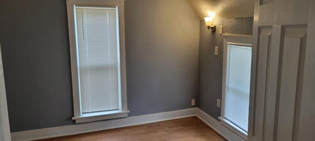 unfurnished room featuring baseboards and wood finished floors