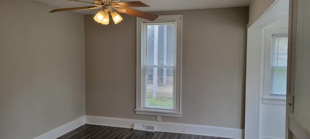 empty room featuring baseboards, ceiling fan, visible vents, and a wealth of natural light