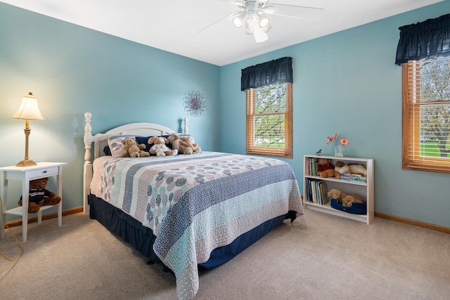 carpeted bedroom featuring baseboards and ceiling fan