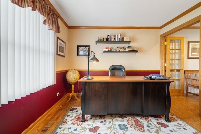 home office with crown molding, wood finished floors, and visible vents