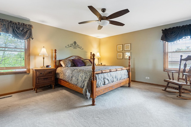 bedroom with light colored carpet, baseboards, and visible vents