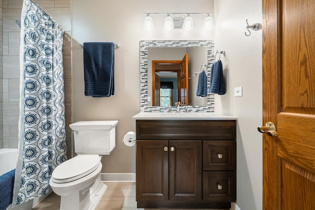 bathroom featuring vanity, baseboards, and toilet